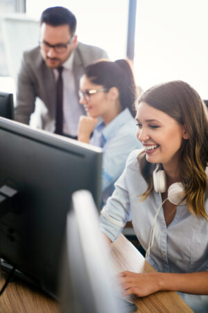 Programmers cooperating working at information technology company
